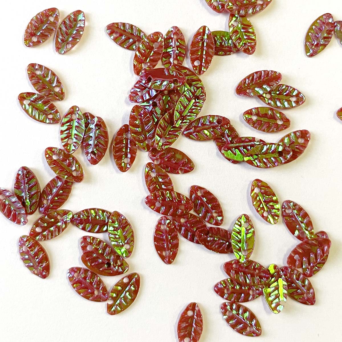 www.colourstreams.com.au Colour Streams Sequins Embellishments Costumes Mardi Gras Dancing Ballet Theatre Shows Drag Queen Bling Sequins Embossed Textured Leaf Shape Iridescent Reflection Shiny Sparkly Muted Red with Green Lights S209 10mm 5mm